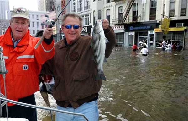 War Criminals on a boat fishing the streets of New Orleans shortly after Hurricane Katrina.  Junior smiles and displays a caught fish, while U.S. citizens walk in (sic) 'waste' deep water covering the streets